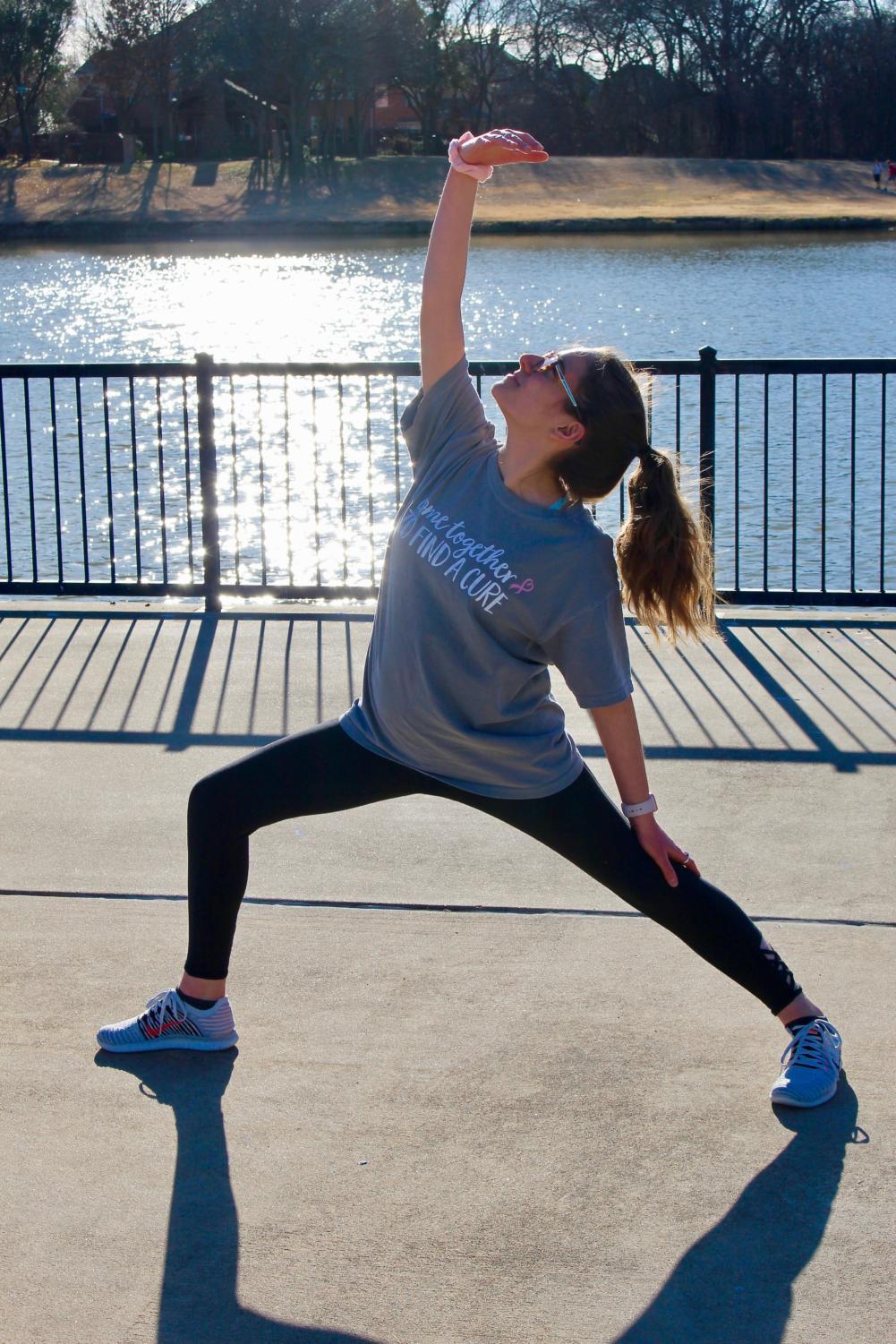 Coppell High School senior Jessica Hernandez practices a peaceful warrior in Andy Brown Park on Wednesday. Hernandez enjoys practicing yoga every day as a part of Adriene Mishler’s 30-day yoga series.  