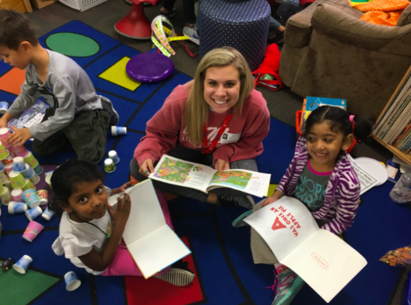 Coppell High School senior Grace Mobley reads with kindergartners at Mockingbird Elementary on Tuesday. Mobley is part of the Ready, Set, Teach! program at CHS which allows students to go to elementary schools and teach children.