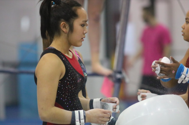 Coppell High School senior Kendal Toy chalks her hands as she gets ready for practice on Feb. 14 at Metroplex Gymnastics. Toy has been practicing gymnastics since she was 3 and is a verbal commit to the University of Washington.