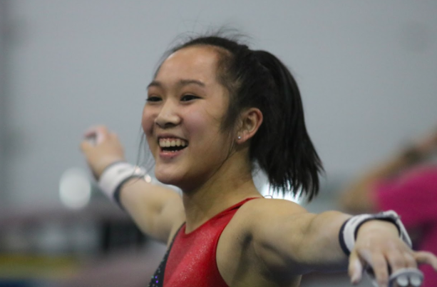 Coppell High School senior Kendal Toy smiles after successfully landing her gymnastics routine during her practice on Wednesday at Metroplex Gymnastics. Toy committed to the University of Washington in 2014 and received a full scholarship.