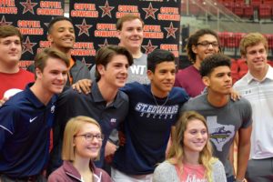 Coppell athletes smile for the camera after signing their letters of intent during the National Signing Day on Feb. 7. Athletes are looking forward to playing at their intended college this upcoming semester in order to pursue their passions.
