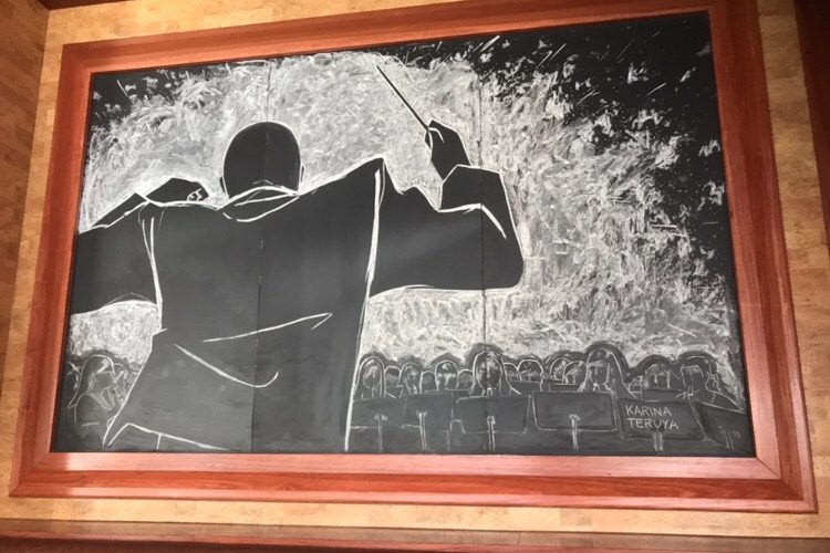 Coppell High School junior Karina Teruya’s chalk drawing Conductor is featured at LARK on the Park, a highly-rated restaurant in Dallas, adjacent to Klyde Warren. LARK selected six artists’ drawings from the Dallas Museum of Art’s Young Masters program to showcase.
