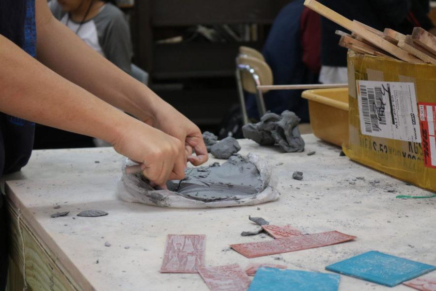 On March 28 at the Coppell High School, Art I students in David Bearden’s enjoy the process of making slabs for their mug. Students were able to cut out their own pieces of clay and enjoy making their mug bases with their classmates.