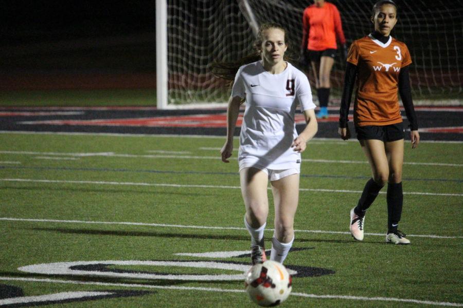 Coppell High School senior Rebecca Watley runs for the ball during the first half of Tuesday nights home game at Buddy Echols Field. The varsity girls soccer team played against WT White taking the win with a score of 5-1.