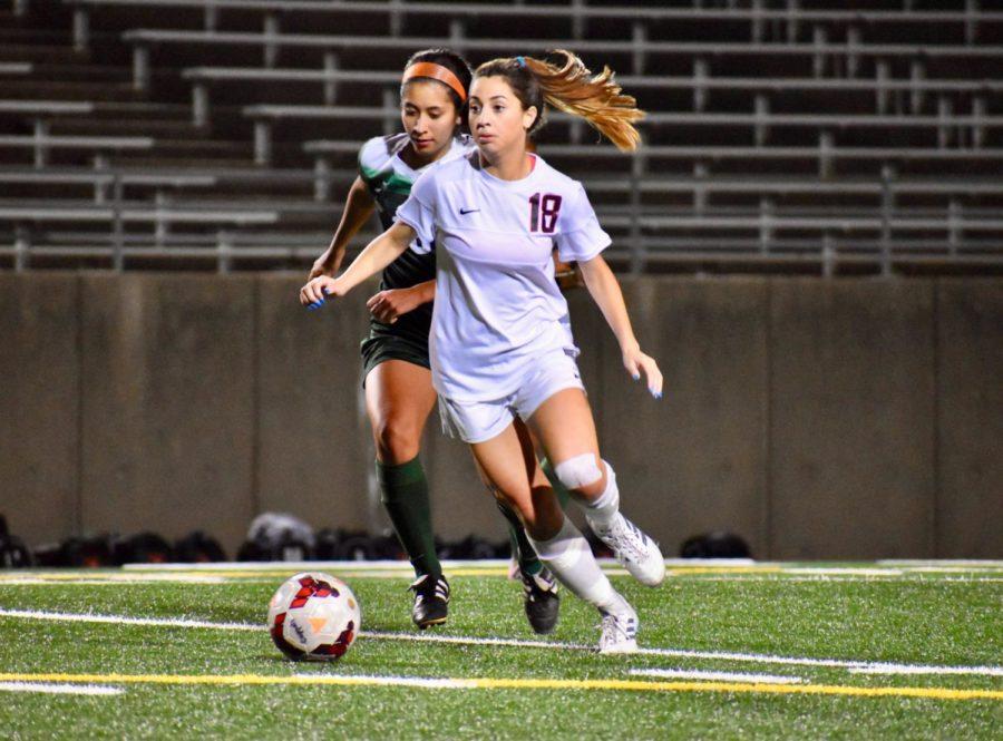 While keeping the opposing team from scoring, Coppell High School sophomore defender Montserrat Lomeli looks for an open pass during the game against the Naaman Lady Rangers on March 29 at the John Clark Field. The Coppell Cowgirls will play again On Friday at Kelly Reeves Athletic Complex in Round Rock.