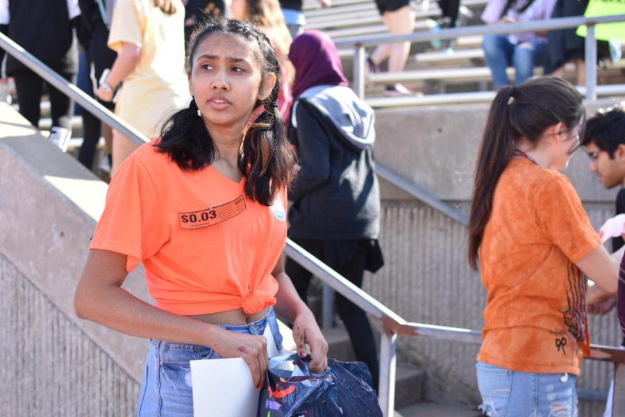 Coppell High School junior Kusha Khandelwal walks out with her poster at the Coppell High School walkout today in the track. The walkout was attended by approximately 700 high school students in support of gun control and school safety.