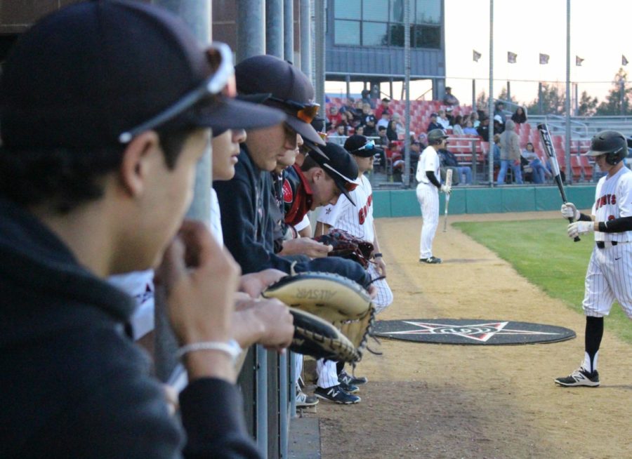 The+Coppell+High+School+varsity+baseball+team+lines+up+in+the+dugout+to+watch+the+first+inning+of+Friday+nights+game+against+the+Skyline+Raiders.+Coppell+pulled+out+a+12-2+win+over+Skyline+at+Cowboy+Field.+