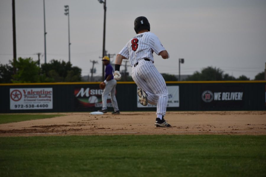 Coppell High School junior Blake Jackson runs to second base after a hit during the first inning of last nights game at the Coppell ISD Baseball/Softball Complex. The Cowboys won their last regular season home game 11-3 against the Richardson Eagles.