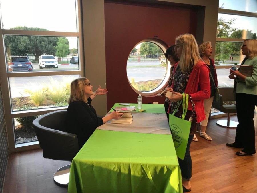 On Friday night at the Cozby Library and Community Commons, best-selling author Julia Heaberlin signs books. Heaberlin visited the library to interact with and answer questions from readers and aspiring writers. 
