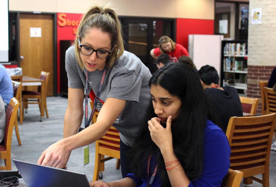 During 6th period, Coppell High School English III teacher M’Lynn Creighton helps a student find a book for Sustained Silent Reading (SSR) using the browser, Destiny, in the library. Creighton is a new teacher who recently moved from Pismo Beach, Calif.