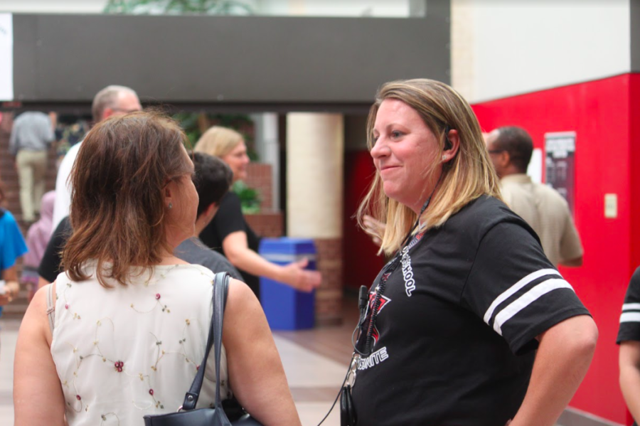 Coppell High School Principal Dr. Nicole Jund helps a parent navigate the halls of CHS during open house on Tuesday night. Open House is an opportunity for parents to walk through their child’s schedules and meet their teachers.