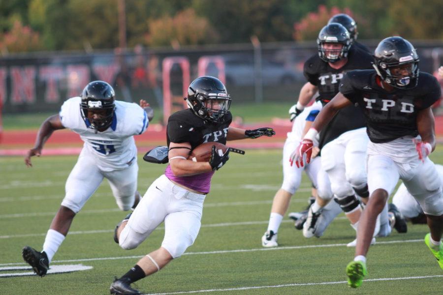 Coppell High School senior running back Ryan Hirt runs past Plano West players on an outside run. The Cowboys scrimmaged the Wolves last night as a preseason look at both teams at Buddy Echols Field. Photo by Bren Flechtner