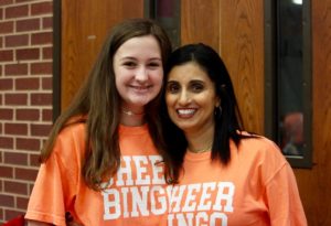 Coppell High School freshman Juliana Hunt and May Olson smile as they wear their cheer bingo shirts to support the cheer team on Friday, Sep. 21 at the Coppell High School Commons. The Coppell High School cheer team hosts their annual bingo night in order to raise money to support their school.