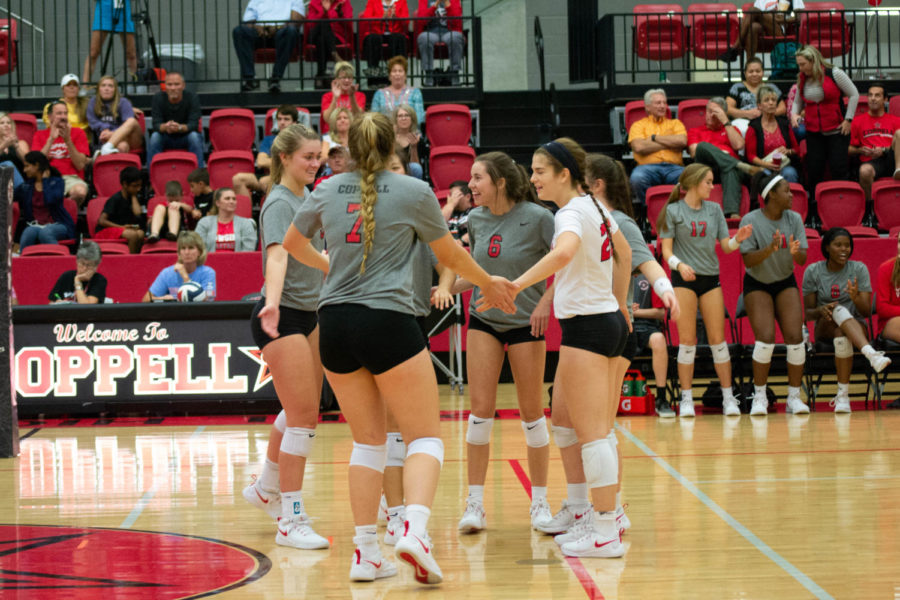 The+Coppell+High+School+Varsity+Volleyball+team+celebrates+their+victory+against+MacArthur.+The+Coppell+Cowgirls+won+the+game+3-0+25-15%2C+25-23%2C+25-6.