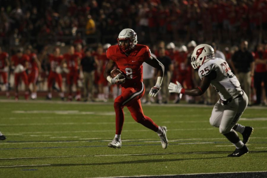 Coppell senior wide reciever Rasheed Noel runs the ball through the MacArthur defense to later score a touchdown. The Coppell Cowboys played against the Cardinals at Buddy Echols Field with the Cowboys winning the score of 28-21.