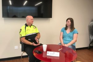 Lewisville resident Cheyenne Baker speaks with Coppell police officer Kirk Smith at the Cozby Library and Community Commons’ Human Library event yesterday. The Human Library is a worldwide program that aims to reduce stereotypes and help people better understand others. 