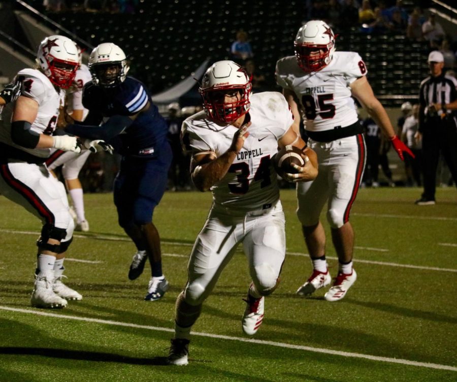 Coppell High School senior running back Ryan Hirt runs past Blue Raiders players on an outside run. The Cowboys defeated the Blue Raiders, 41-7.