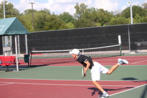 Coppell High School junior Mihiro Suzuki returns the last shot of his doubles match with Coppell High School freshman Andreja Zrnic against Marcus High School on September 18. Suzuki and Zrnic lost 8-6 while the team overall won 12-7.
