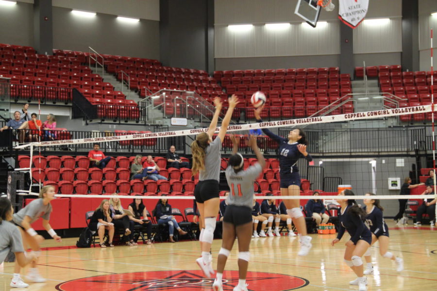 Coppell High School sophomore Madison Gilliland and senior Britney Loyd block the ball during the game in the CHS Arena on September 14th. The Cowgirls defeated the Irving Nimitz in three out of three sets.