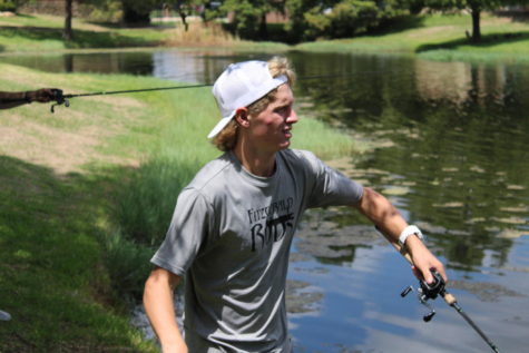 Coppell High School senior Calan Cameron feels a tug on his fishing line on Sep. 2 at the pond by the Cozby Library and Community Commons. Cameron is pursuing his passion for fishing to start a business called Coppell Youth Fishing Trips.