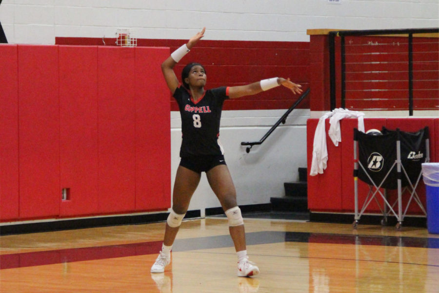 Coppell+Cowgirl+senior+Amarachi+Osuji+serves+the+ball+during+the+game+against+Keller+Varsity+volleyball+team.+The+Coppell+Cowgirls+won+the+game+25-18%2C+23-25%2C+25-23%2C+25-20.