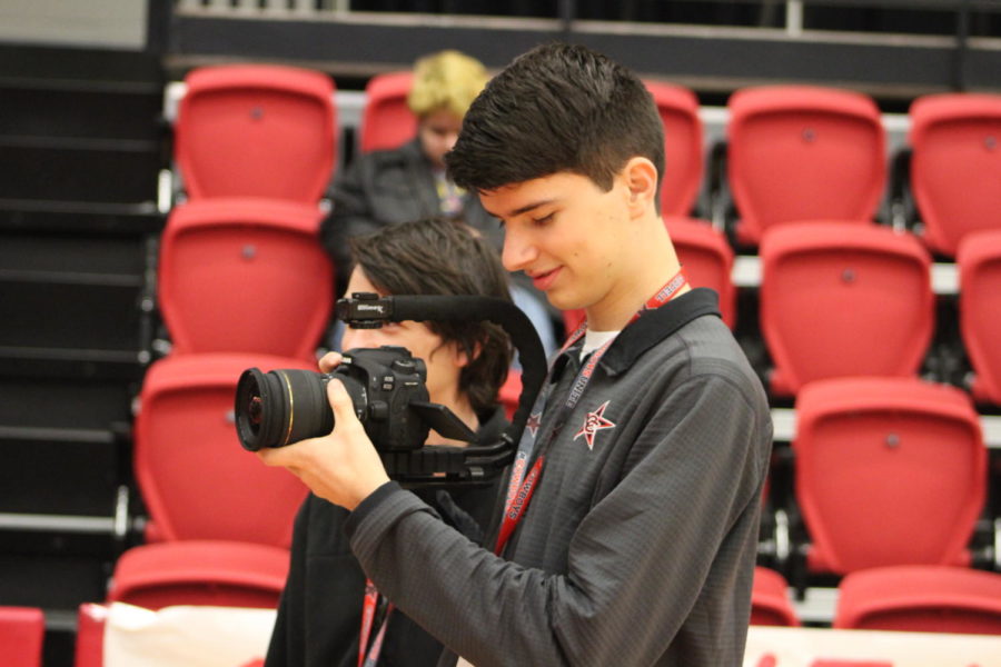 Coppell High School senior Landon Flesher takes video of the pep-rally on Oct. 19, in the CHS arena. Flesher has been a member of KCBY for the past three years of highschool. 
