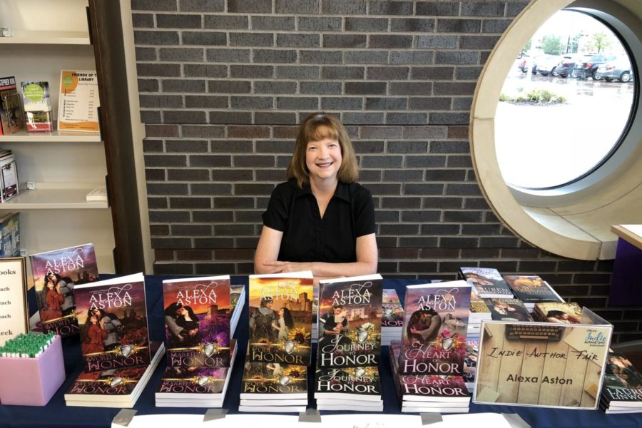 Author+Alexa+Aston+talks+about+her+published+books+with+visitors+at+the+2018+Indie+Author+Fair.+This+year%E2%80%99s+event%2C+hosted+at+the+Cozby+Library+and+Community+Commons%2C+is+on+Saturday+where+local+authors+introduce+and+talk+about+their+books.+Sidekick+File+Photo%0A