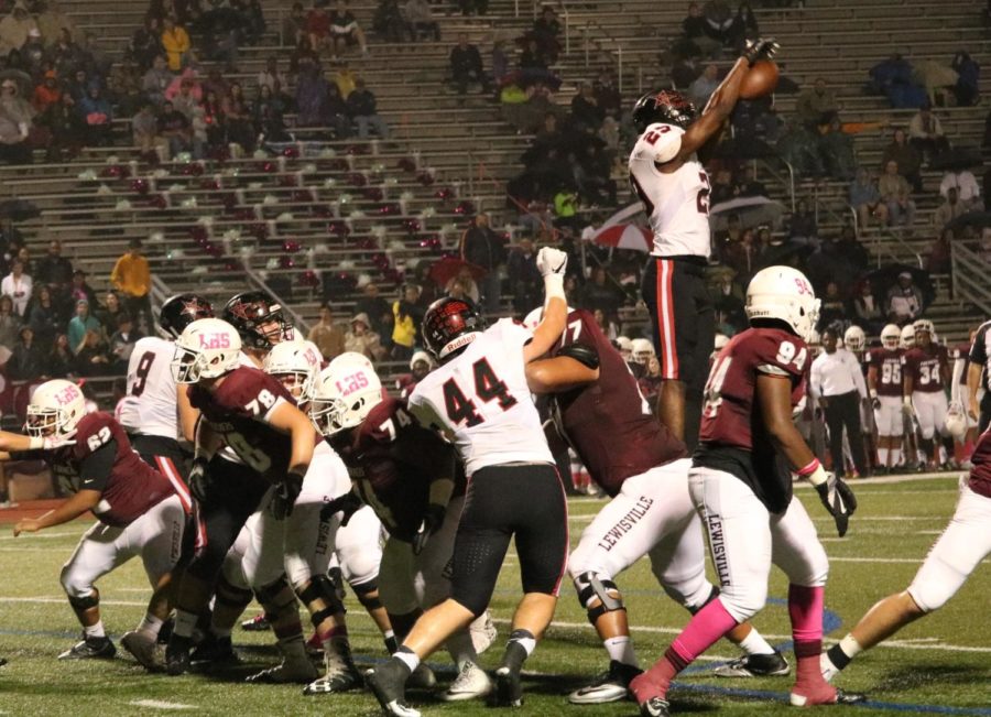 Coppell senior defensive end Tochi Ugwulebo blocks a Lewisville field goal during the second quarter. The Cowboys lost, 13-6, to the Farmers at Max Goldsmith Stadium on Friday.