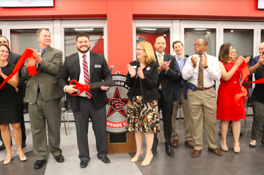 CHS9+Principal+Cody+Koontz+cuts+the+red+ribbon+with+Coppell+ISD+Superintendent+Brad+Hunt+and+other+Board+of+Trustees+members+to+signify+the+opening+of+the+Coppell+High+School+ninth+grade+campus.+This+new+ninth+grade+center+was+a+result+of+a+remodeling+of+the+former+Coppell+Middle+School+West.