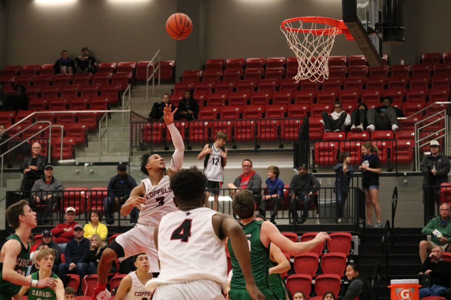 Coppell senior guard Tariq Aman goes up for a layup on Saturday against Carroll in the CHS arena. The Cowboys lost to the Dragons, 70-53, in their first game of the season.