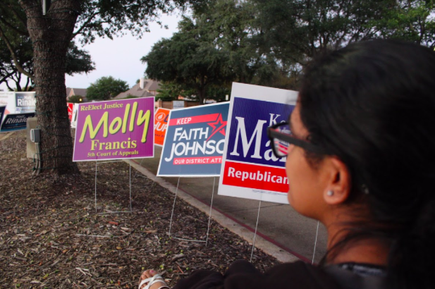 Staff writer Anika Arutla talks about the history of voting and her excitement about voting. Political signs are lined along the road to Coppell Town Center for upcoming midterm election on Nov. 9. 