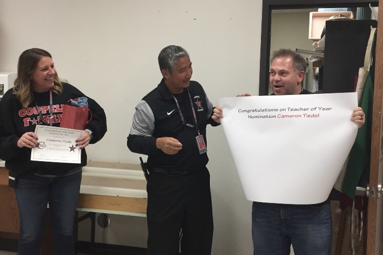 Coppell High School Principal Dr. Nicole Jund and assistant principal Ryan Lam present CHS teacher Cameron Tiede with his Teacher of the Year nomination on Nov. 15. A total of 10 teachers were nominated, and the winner will be announced on Nov. 28 in the CHS Arena. 