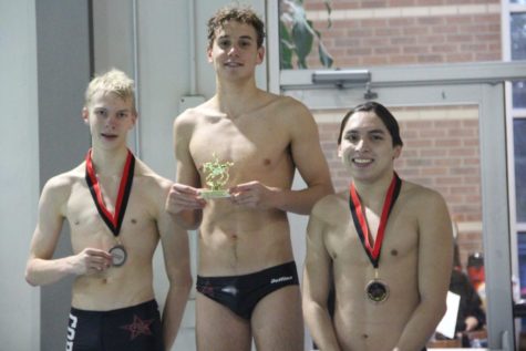 Coppell High School junior Johan Pretorius accepts his trophy for the 50-yard butterfly with CHS seniors Emil Aaltonen and Elieser Gonzales at the Vaquero Battle on Nov. 9 at the Coppell YMCA. Pretorius was the only CHS swimmer to go to state last year and set a pool record at the TISCA invitational in Texarkana.