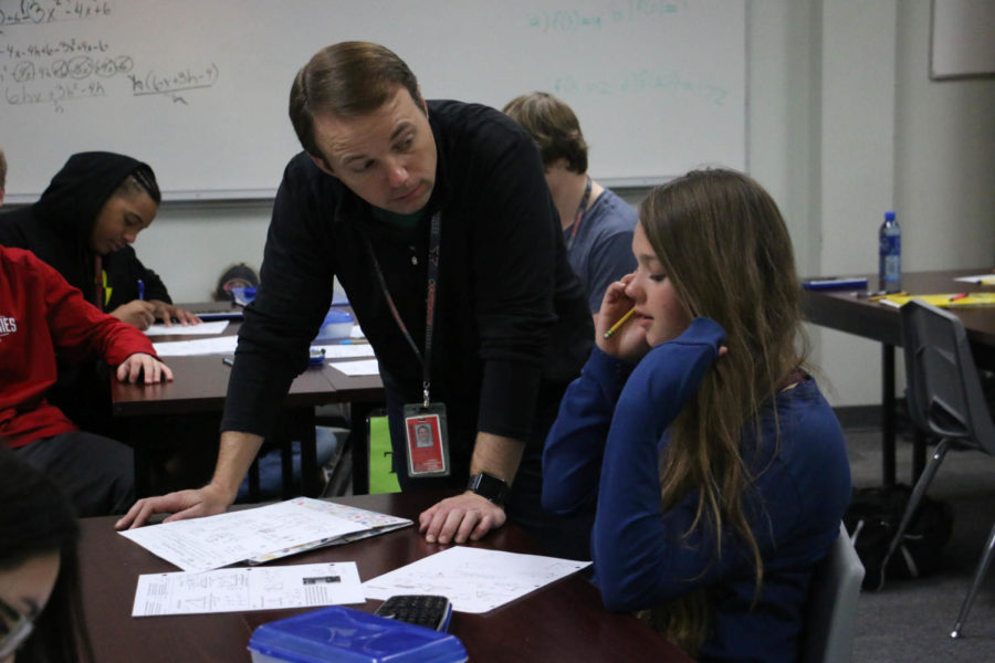 On Jan 30, Coppell High School math teacher John Watkins helps CHS sophomore Zoe Goodale with her worksheet over the pythagorean theorem. Watkins was chosen as Teacher of the Week because of how he incorporates life lessons into his daily teaching.