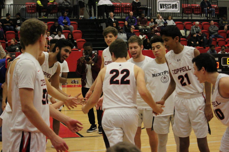 Coppell+junior+Dan+Igrisan+high+fives+his+fellow+teammates+as+an+introduction+on+Tuesday+Jan+22+at+CHS+arena.+The+Coppell+Cowboys+lost+to+the+Lewisville+Farmers+71-57.+