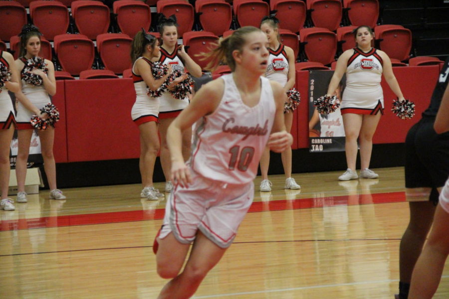 Coppell+sophomore+Emma+Sherrer+runs+to+keep+her+eyes+on+the+ball+on+Tuesday+Jan.+29+at+the+CHS+arena.+The+Coppell+Cowgirls+defeated+the+Irving+Tigers+75-36.+