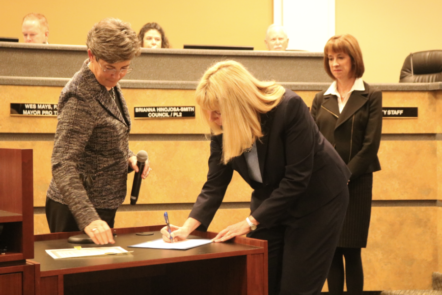 Kristine Schwan Primrose signs the motion sent in place to appoint her as the alternate municipal judge during the Coppell City Council Meeting on Jan. 8. Judge Primrose was selected after the current municipal judge Terry Landwehr received a higher position.