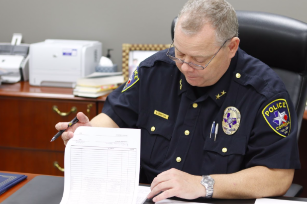 Coppell Police Chief Danny Barton looks through paperwork in his new office at the Coppell Police Station on Dec. 14. Barton has been a part of the police force for more than 20 years and was sworn in as Coppell Police Chief on Dec. 3.
