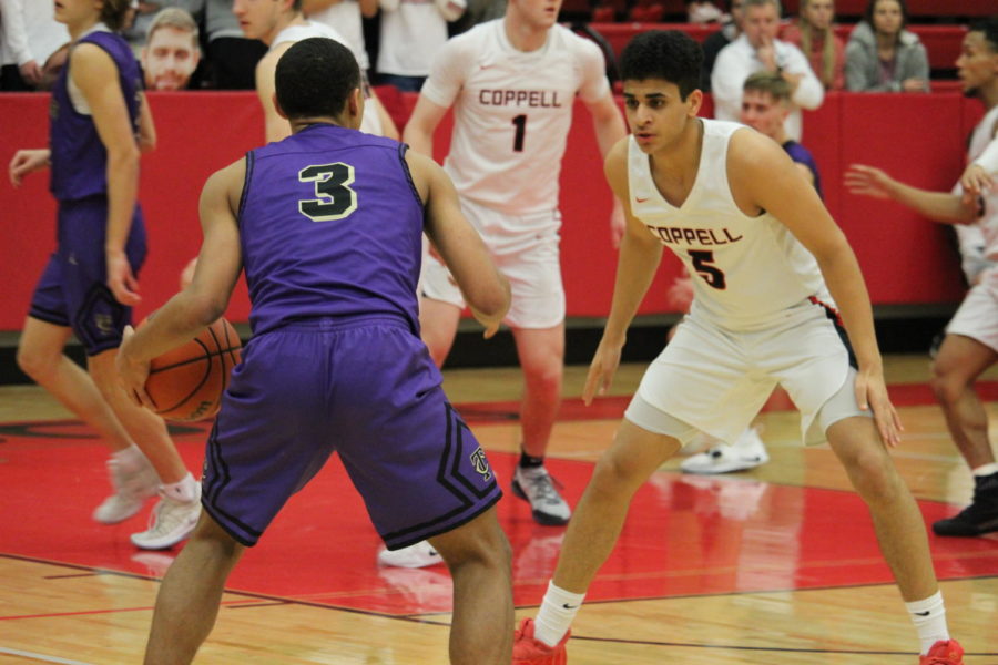 Coppell junior Adam Moussa guards the ball against Keller Timber Creek on Feb. 19, at CHS Arena. Moussa shot a three in the final 20
seconds of the BI-District Playoffs to send the Cowboys to a 53-51 win. The Cowboys are moving on to the Championship against Lake Ridge on Feb. 21.