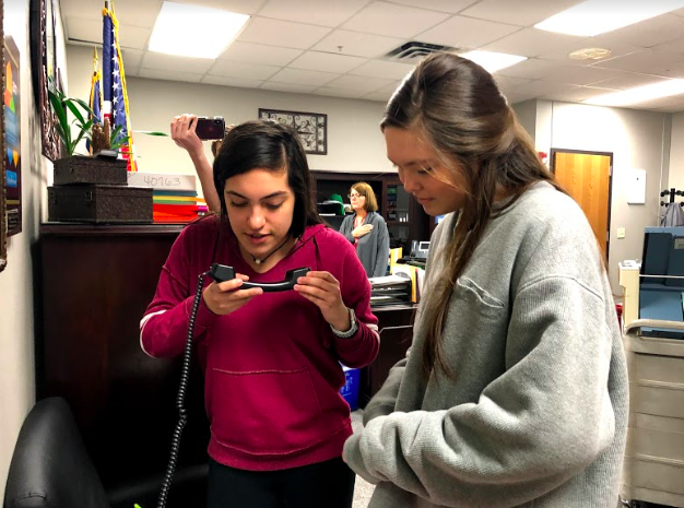 Coppell+High+School+Red+Jacket+seniors+Jimena+Benavides+and+Addison+Sork+announce+the+pledges+over+the+intercom+during+seventh+period+in+the+administration+office.+Red+Jackets+announce+pledges+everyday+during+third%2Fseventh+period.+Photo+by+Nevaeh+Jones.+