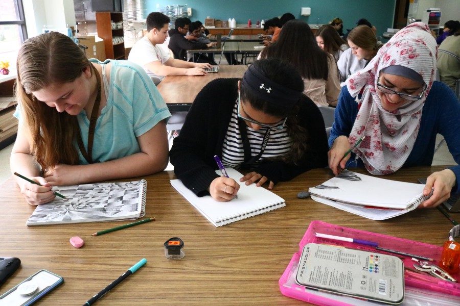 Coppell High School sophomores Jordan Buffington, Roshni Patel and Bushes Issa work on portraits and shading during seventh period on Friday in CHS teacher David Bearden’s Art l honors class. To celebrate Youth Art Month, Art l is in their portrait unit to strengthen their skills as visual drawers.