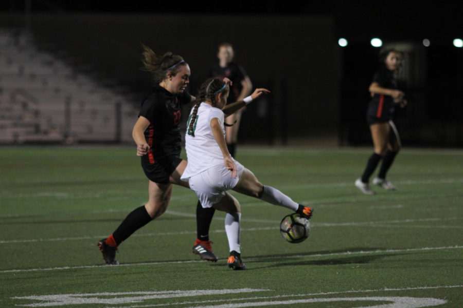 Coppell sophomore Maya Ozymy takes the ball from a Mansfield Lake Ridge defender on Tuesday night at Pennington Field in Bedford. In overtime, the Coppell girls soccer team defeated Lake Ridge, 1-0, in the Class 6A Region I area playoffs. 