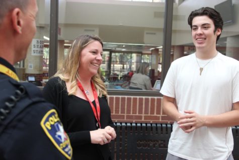 Coppell High School Principal Dr. Nicole Jund is seen with CHS Student Resource Officer Chris Cobb and CHS senior CJ Ward in the main hallway last year. On Monday, Dr. Jund was announced the Coppell ISD assistant athletic director. Coppell Middle School East Principal Laura Springer will be returning as the new CHS principal
