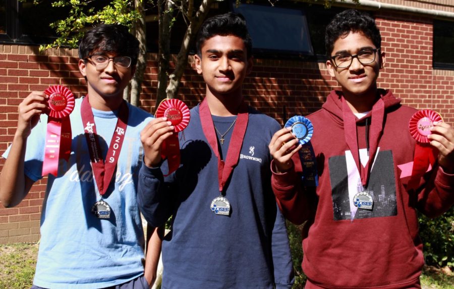 Coppell High School sophomore Karthik Karupiah, junior Tom Vazhekatt and sophomore Zach Vazhekatt showcase their awards from the annual Texas Science and Engineering Fair in the CHS garden on April 8. These three students finished second place in the TXSEF state science fair in the Plants Science division. 