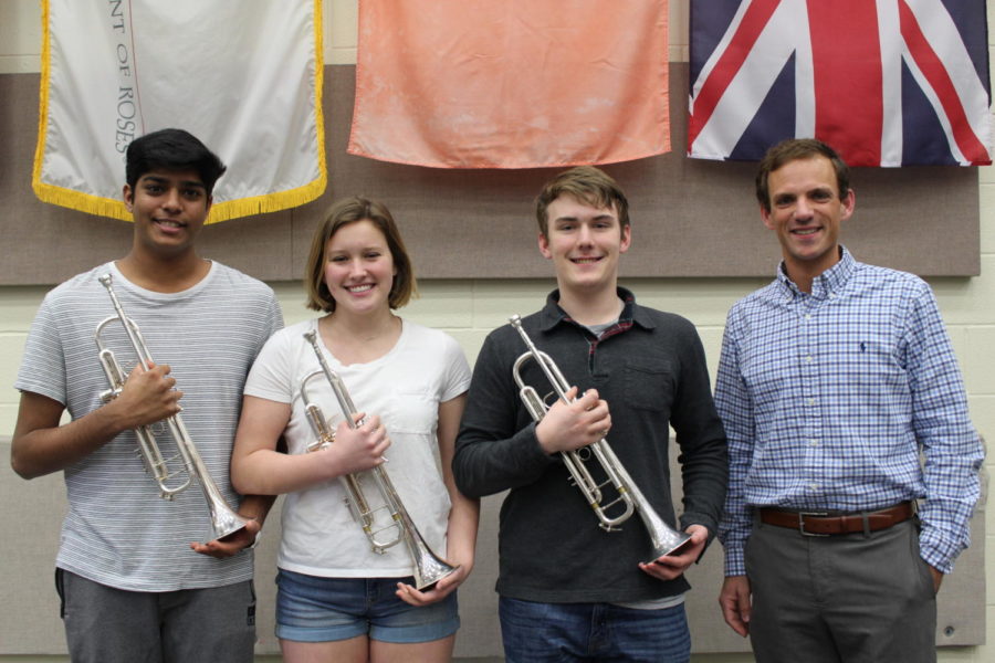 Coppell High School senior Supratik Pochampally, junior Terri Rauschenbach and senior Trevor Holmes stand with CISD Trumpet Instructor Dr. Jared Hunt in the CHS band room. The Ensemble won first place in the Trumpet Ensemble Division at the National Trumpet Competition on March 16 at the University of Kentucky in Lexington, Ky.