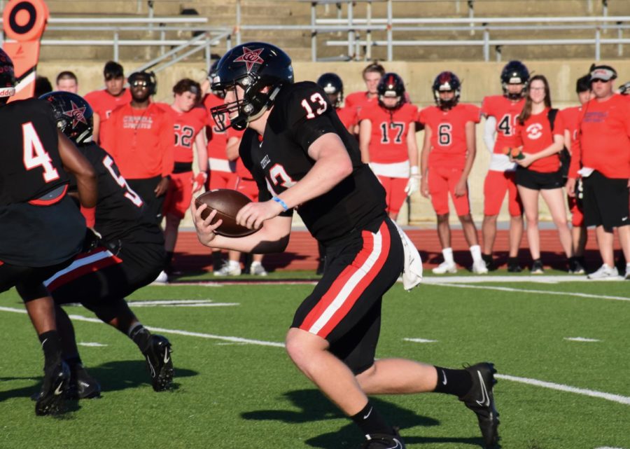 The Black team junior quarterback Drew Cerniglia rushing towards a first down during the annual spring football game. The Black team came up on top 14-7 during the friendly game.
