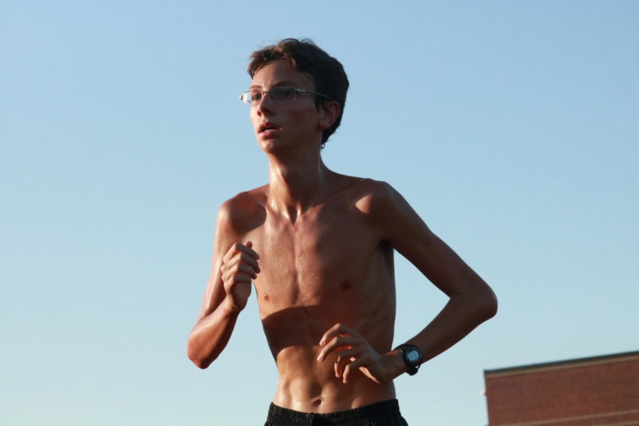 During a morning run, Coppell High School sophomore Lane Jacobs looks towards the finish line. CHS cross country runners train intensely seven days a week, and athletes even continue waking up early during summer while most others sleep in.