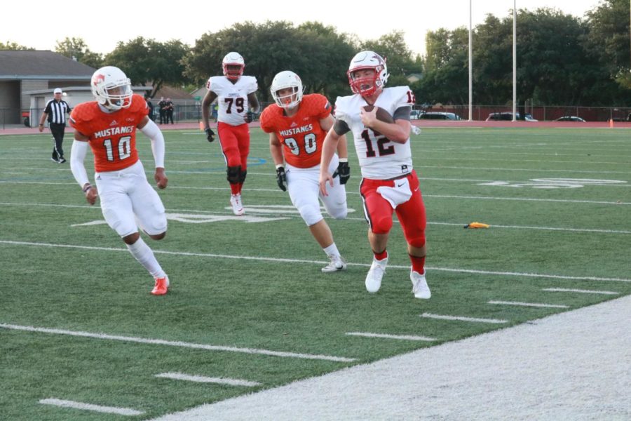 Coppell senior quarterback Kevin Shuman rushes down the sideline against Sachse on Friday night at Williams Stadium, in Garland. The Mustangs defeated the Cowboys, 33-30, in the regular season opener