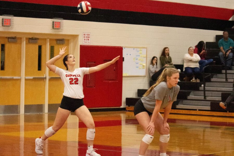 Coppell+senior+libero+Maci+Watrous+serves+against+Irving+MacArthur+during+the+2018-19+season.+The+Cowgirls+face+McKinneyl+on+Tuesday+at+6%3A30+in+the+CHS+Arena.