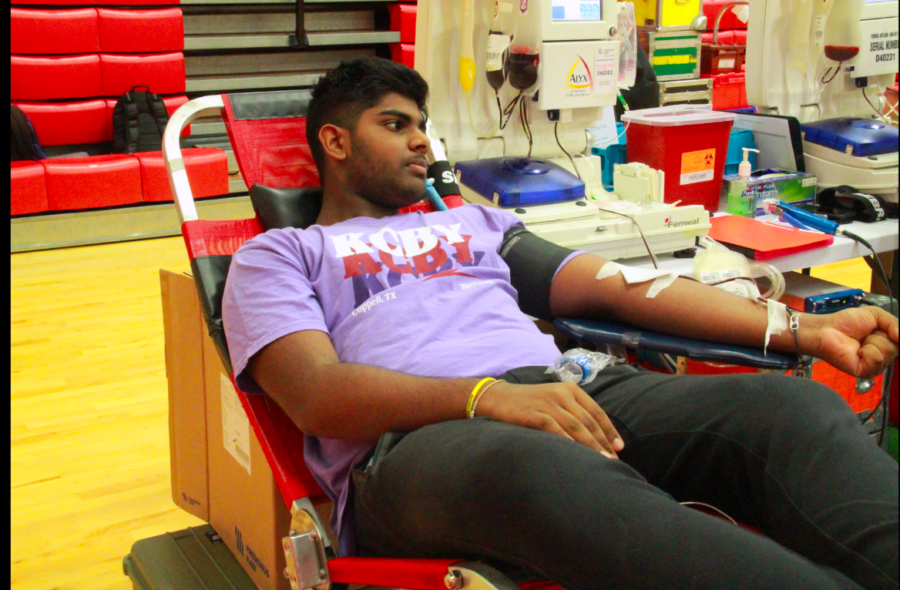 Coppell High School senior Rishi Mekka gets his blood drawn during second period in the small gym on Friday. Students and faculty were able to sign up to donate blood through the Health Occupational Students of America blood drive today. 